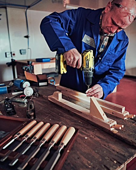 Craftsman assembling sofa frame